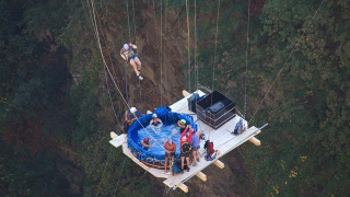 Illustration for article titled Crazy Swiss Swingers Suspend Hot Tub from Bridge